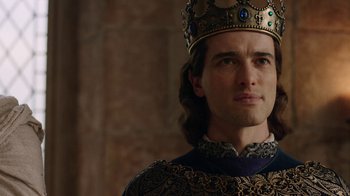 Movie still from “Knightfall” (2017), created by Richard Rayner – A person wearing a crown; Close Up shot, Over the shoulder angle