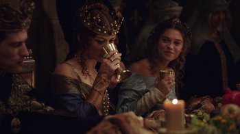 Movie still from “Knightfall” (2017), created by Richard Rayner – Two women in medieval garb drinking wine at a dinner table; Medium shot, Over the shoulder angle
