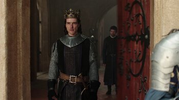 Movie still from “Knightfall” (2017), created by Richard Rayner – A man wearing a crown standing next to another man; Medium shot, Over the shoulder angle