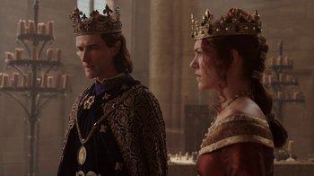 Movie still from “Knightfall” (2017), created by Richard Rayner – A man and a woman in medieval garb standing next to each other; Medium shot, Over the shoulder angle