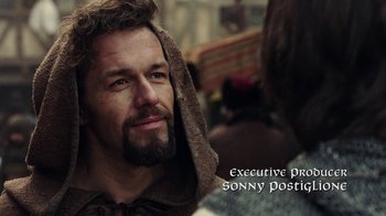 Movie still from “Knightfall” (2017), created by Richard Rayner – A person with a beard wearing a robe; Close Up shot, Over the shoulder angle