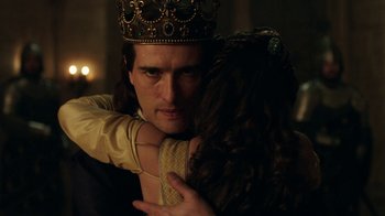 Movie still from “Knightfall” (2017), created by Richard Rayner – A man and a woman embracing each other in a dark room; Close Up shot, Over the shoulder angle