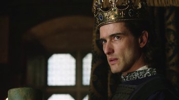 Movie still from “Knightfall” (2017), created by Richard Rayner – A person wearing a crown; Close Up shot, Low angle