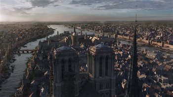 Movie still from “Knightfall” (2017), created by Richard Rayner – An aerial view of a large city with a river in the background; Extreme Wide shot, High angle