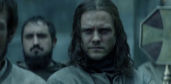 Movie still from “Knightfall” (2017), created by Richard Rayner – A person with long hair; Close Up shot, Over the shoulder angle