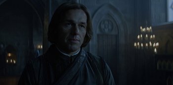 Movie still from “Knightfall” (2017), created by Richard Rayner – A person wearing a suit; Close Up shot, Over the shoulder angle