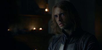 Movie still from “Knightfall” (2017), created by Richard Rayner – A person with long hair; Close Up shot, Over the shoulder angle