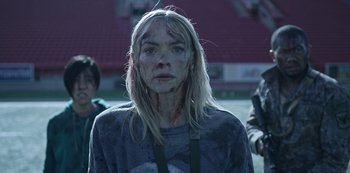 Movie still from “Black Summer” (2019), created by John Hyams – A woman with blood all over her face and neck; Medium shot, Over the shoulder angle
