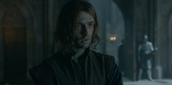 Movie still from “Knightfall” (2017), created by Richard Rayner – A person with long brown hair; Close Up shot, Over the shoulder angle