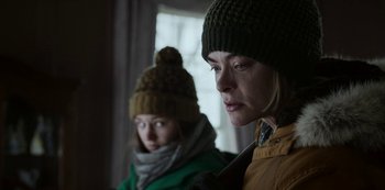 Movie still from “Black Summer” (2019), created by John Hyams – Two women wearing winter hats looking at the camera; Close Up shot, Over the shoulder angle