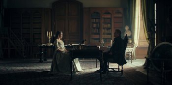 A man and a woman sitting at a table in a room