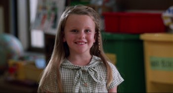 Movie still from “Liar Liar” (1997), directed by Tom Shadyac – A little girl with long blonde hair wearing a plaid dress; Close Up shot, High angle