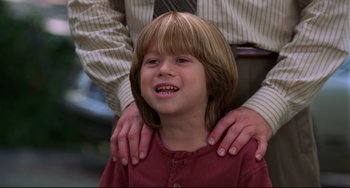 Movie still from “Liar Liar” (1997), directed by Tom Shadyac – A person with a child; Close Up shot, Low angle