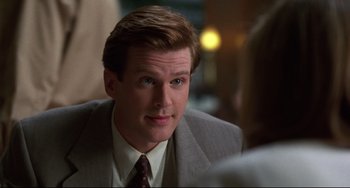 Movie still from “Liar Liar” (1997), directed by Tom Shadyac – A person wearing a suit and tie; Close Up shot, Over the shoulder angle