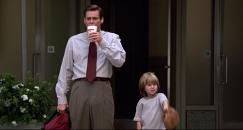 Movie still from “Liar Liar” (1997), directed by Tom Shadyac – A man and a boy are walking down the street; Medium shot, Low angle