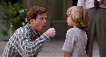 Movie still from “Liar Liar” (1997), directed by Tom Shadyac – A man and a boy talking to each other; Medium shot, Over the shoulder angle