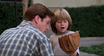 Movie still from “Liar Liar” (1997), directed by Tom Shadyac – A man and a boy looking at a baseball glove; Close Up shot, Over the shoulder angle