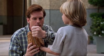 Movie still from “Liar Liar” (1997), directed by Tom Shadyac – A man holding a baseball glove with a boy; Close Up shot, Over the shoulder angle