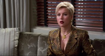 Movie still from “Liar Liar” (1997), directed by Tom Shadyac – A woman with short blonde hair sitting on top of a couch; Close Up shot, Over the shoulder angle