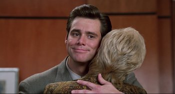 Movie still from “Liar Liar” (1997), directed by Tom Shadyac – A man and a woman hugging and smiling; Close Up shot, Over the shoulder angle