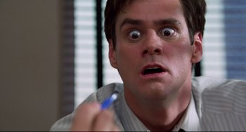 Movie still from “Liar Liar” (1997), directed by Tom Shadyac – A person holding a pen in his hand; Close Up shot, Low angle