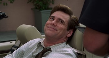 Movie still from “Liar Liar” (1997), directed by Tom Shadyac – A man in a tie sitting in a chair looking up; Close Up shot, Low angle