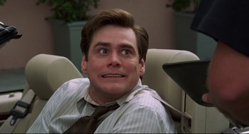 Movie still from “Liar Liar” (1997), directed by Tom Shadyac – A person sitting in a chair; Close Up shot, Over the shoulder angle