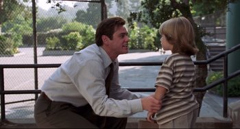 Movie still from “Liar Liar” (1997), directed by Tom Shadyac – A man and a boy are talking to each other outside; Medium shot, Over the shoulder angle