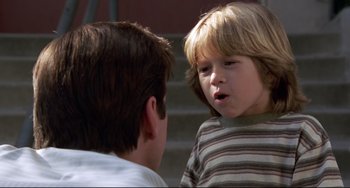 Movie still from “Liar Liar” (1997), directed by Tom Shadyac – A young boy talking to another young boy; Close Up shot, Over the shoulder angle