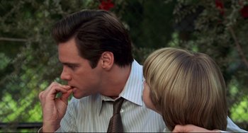 Movie still from “Liar Liar” (1997), directed by Tom Shadyac – A man and a boy are eating some food together; Close Up shot, Over the shoulder angle