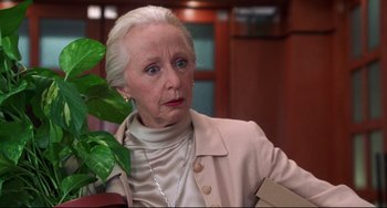 Movie still from “Liar Liar” (1997), directed by Tom Shadyac – An older woman in a beige jacket is looking at the camera; Close Up shot, Low angle