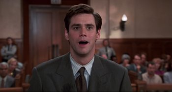 Movie still from “Liar Liar” (1997), directed by Tom Shadyac – A person wearing a suit and tie; Close Up shot, Low angle