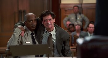 Movie still from “Liar Liar” (1997), directed by Tom Shadyac – Two men in a court room , one of whom has his mouth open; Medium shot, Low angle