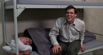 Movie still from “Liar Liar” (1997), directed by Tom Shadyac – Two men sitting on top of a bunk bed next to each other; Medium shot, High angle