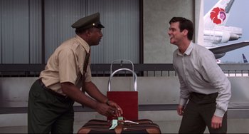 Movie still from “Liar Liar” (1997), directed by Tom Shadyac – Two men are laughing while one of them is holding a suitcase; Medium shot, Low angle