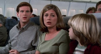 Movie still from “Liar Liar” (1997), directed by Tom Shadyac – A man and a woman sitting next to each other on a plane; Close Up shot, Low angle