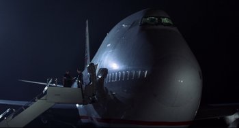 Movie still from “Liar Liar” (1997), directed by Tom Shadyac – A large jetliner sitting on top of an airport runway; Extreme Wide shot, Low angle