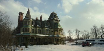 Movie still from “Locke & Key” (2020), created by Carlton Cuse – An old mansion with a snow covered ground and trees in the background; Extreme Wide shot, Low angle