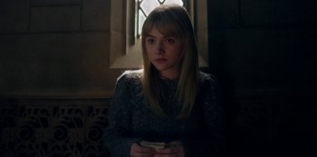 Movie still from “Locke & Key” (2020), created by Carlton Cuse – A woman holding a cell phone in front of a window; Medium shot, Over the shoulder angle