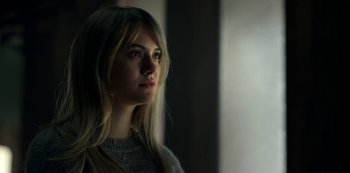 Movie still from “Locke & Key” (2020), created by Carlton Cuse – A beautiful young lady with long blonde hair wearing a gray sweater; Close Up shot, Low angle