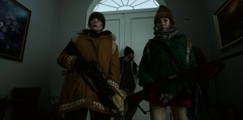 Movie still from “Black Summer” (2019), created by John Hyams – Two women in winter coats and a man with a gun; Medium shot, Low angle