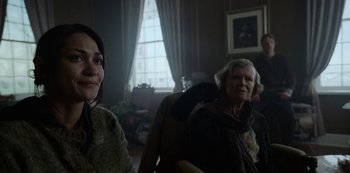 Movie still from “Black Summer” (2019), created by John Hyams – Two women sitting in a living room next to each other; Close Up shot, Over the shoulder angle