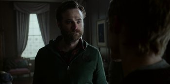 Movie still from “Black Summer” (2019), created by John Hyams – A man with a goatee standing next to a woman; Close Up shot, Over the shoulder angle