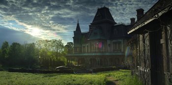 Movie still from “Locke & Key” (2020), created by Carlton Cuse – An old house with a lot of green grass in front of it; Extreme Wide shot, Low angle