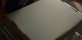 Movie still from “Locke & Key” (2020), created by Carlton Cuse – A pizza box on a wooden table; Extreme Close Up shot, High angle