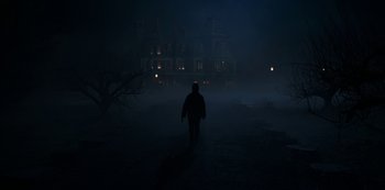 Movie still from “Locke & Key” (2020), created by Carlton Cuse – A person walking in the dark in front of a house; Extreme Wide shot, Low angle