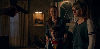 Movie still from “Locke & Key” (2020), created by Carlton Cuse – A woman and two young children in a room; Medium shot, Over the shoulder angle