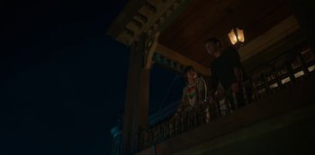 Movie still from “Locke & Key” (2020), created by Carlton Cuse – Two people standing on a balcony at night; Medium shot, Low angle