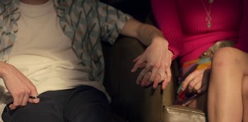 Movie still from “Locke & Key” (2020), created by Carlton Cuse – Two people holding hands while sitting on a couch; Extreme Close Up shot, High angle