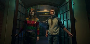 Movie still from “Locke & Key” (2020), created by Carlton Cuse – A man and a woman walking through a tunnel; Medium shot, Low angle